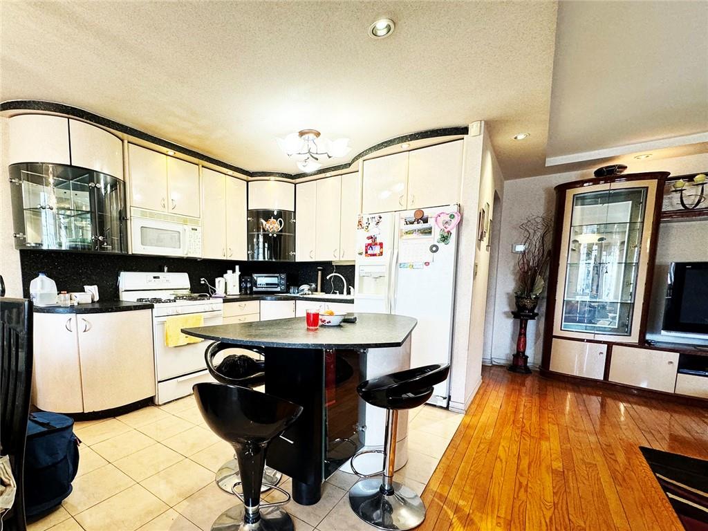 249 Bay 22nd Street Brooklyn, NY 11214 - Photo 3 of 12 a kitchen with a sink appliances and cabinets