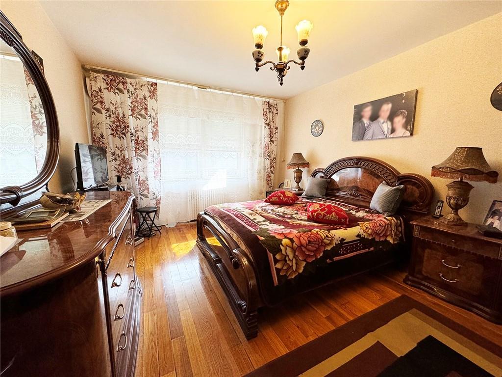 249 Bay 22nd Street Brooklyn, NY 11214 - Photo 6 of 12 a bedroom with a bed and wooden floor