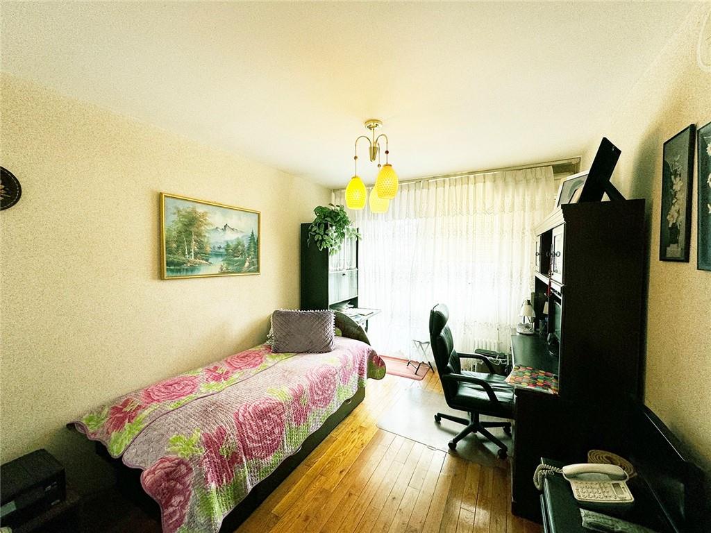 249 Bay 22nd Street Brooklyn, NY 11214 - Photo 7 of 12 a bedroom with a bed flat screen tv and window