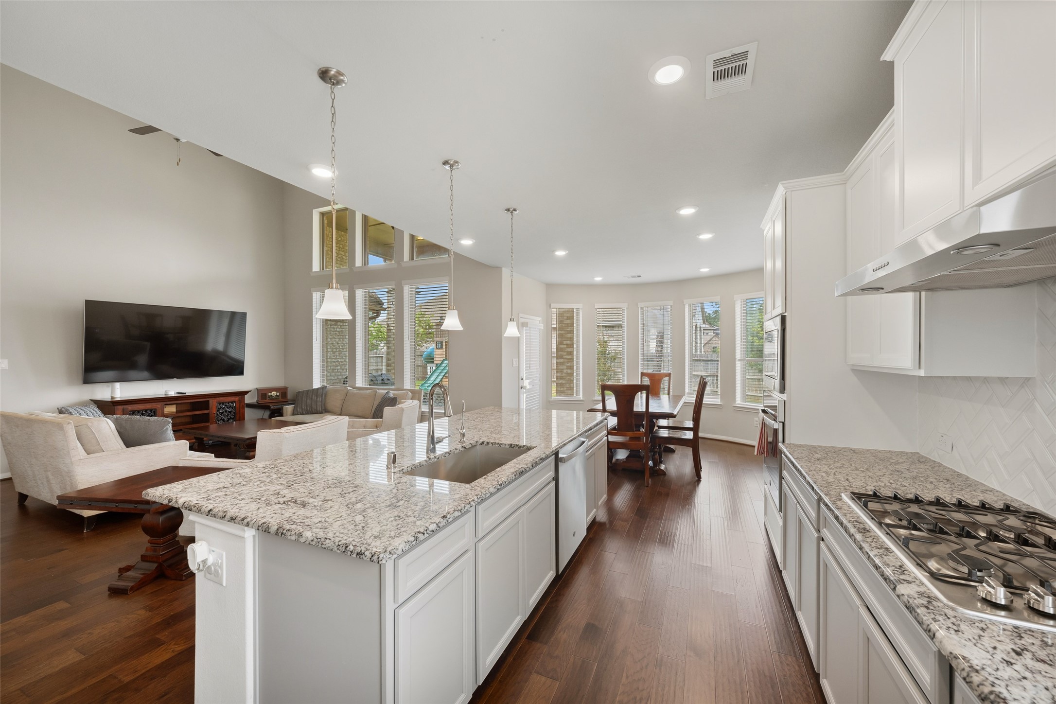 17323 Grand Canyon Road Conroe, TX 77302 - Photo 12 of 33 A good 3-point work flow in the kitchen with the large dining area beyond.