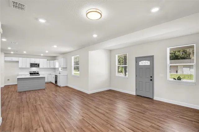 a view of kitchen with sink and wooden floor