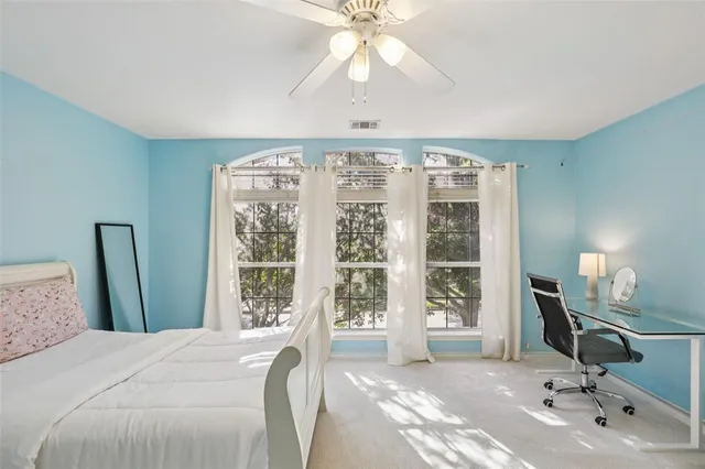 a bedroom with a large bed and a window