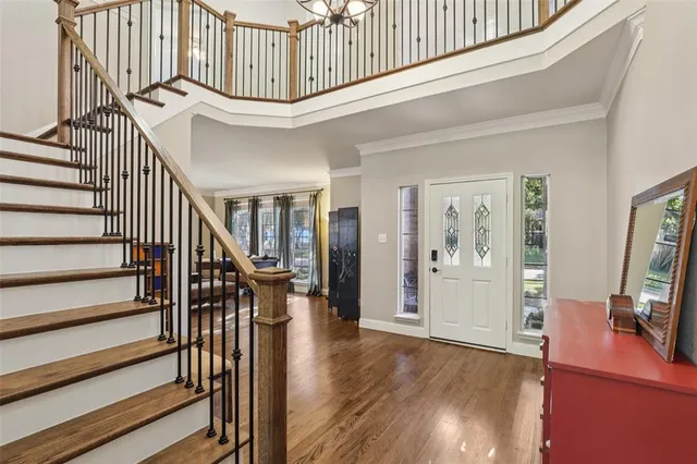 a view of entryway and hall with wooden floor