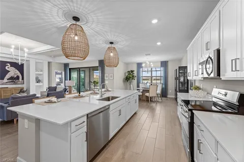 a kitchen with sink stove and cabinets