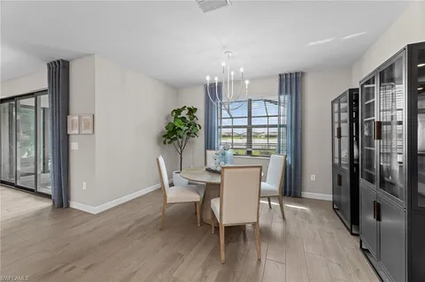 a kitchen with stainless steel appliances granite countertop a stove a microwave oven a island with a dining table and chairs