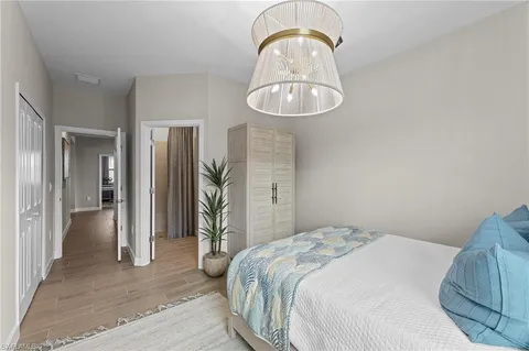 a bedroom with a bed and a chandelier