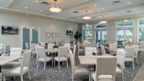 a living room with lots of furniture and view of kitchen