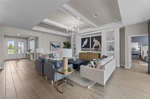 a living room with fireplace furniture and a wooden floor