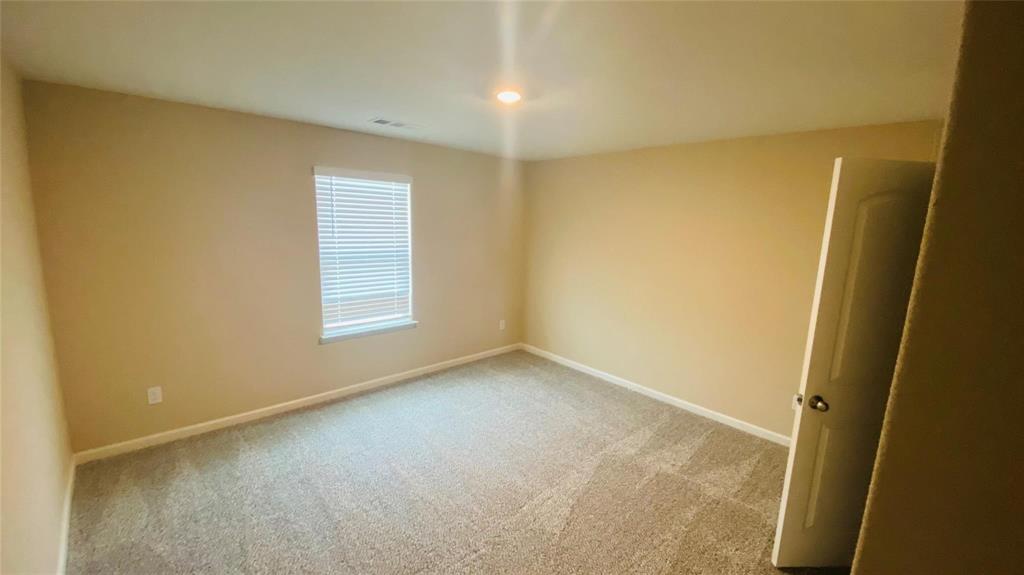 261 Moonstone Way Princeton, TX 75407 - Photo 8 of 9 an empty room with windows
