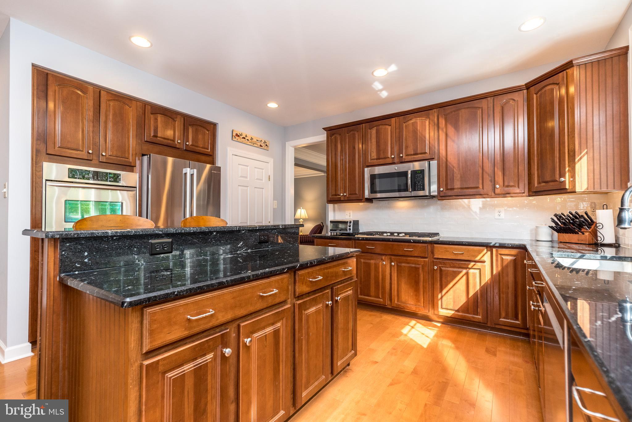 315 Kennard Road Perkasie, PA 18944 - Photo 12 of 51 a kitchen with stainless steel appliances granite countertop wooden cabinets a stove top oven a sink and dishwasher