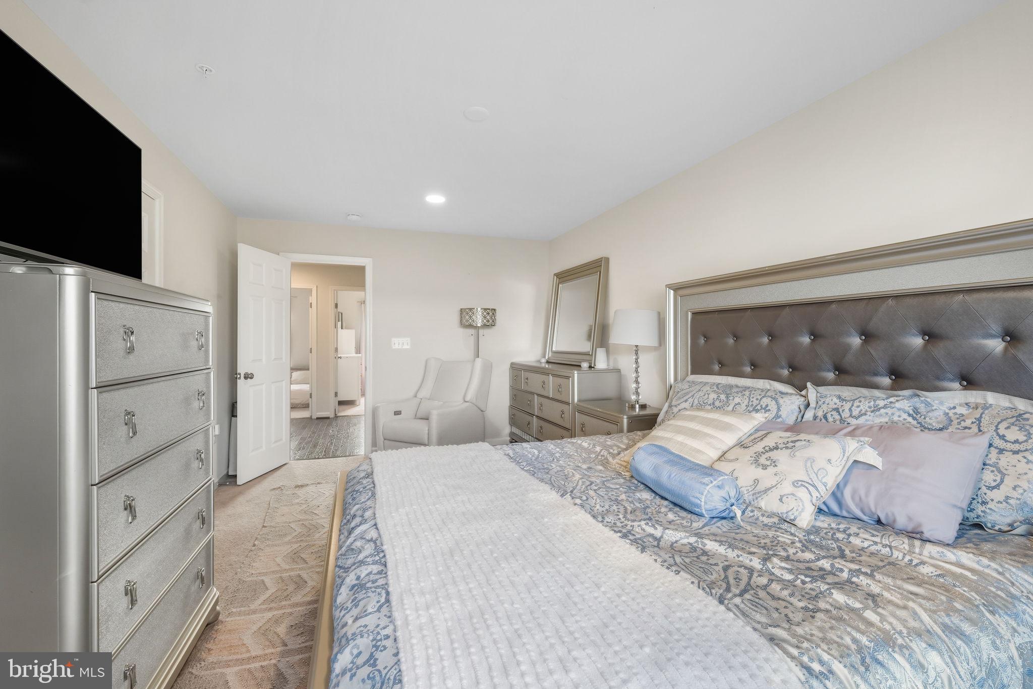 15635 Trolley Lane Silver Spring, MD 20906 - Photo 21 of 41 a spacious bedroom with a large bed and a flat screen tv