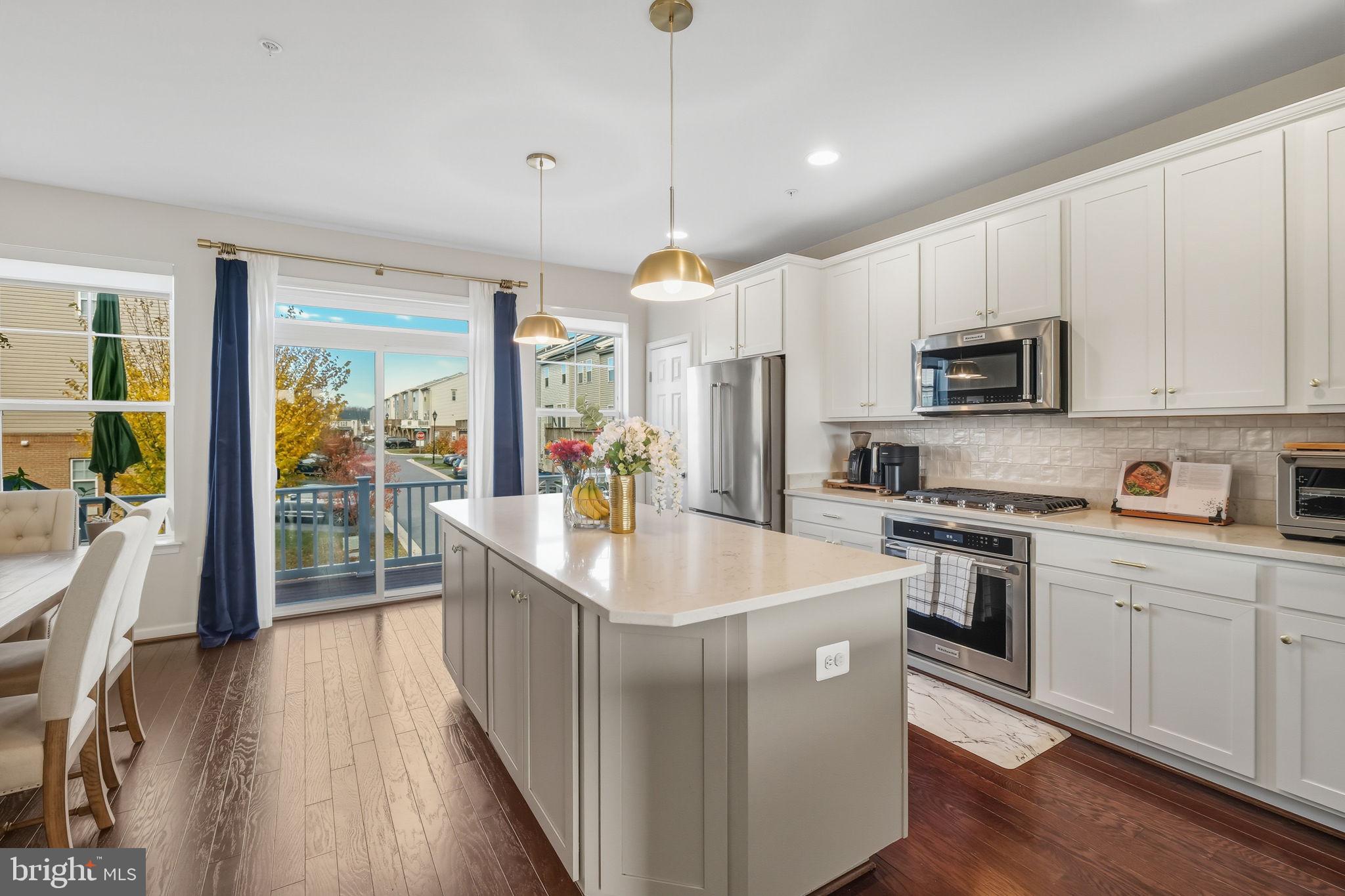 15635 Trolley Lane Silver Spring, MD 20906 - Photo 8 of 41 a kitchen with kitchen island granite countertop a stove a sink a center island and a window
