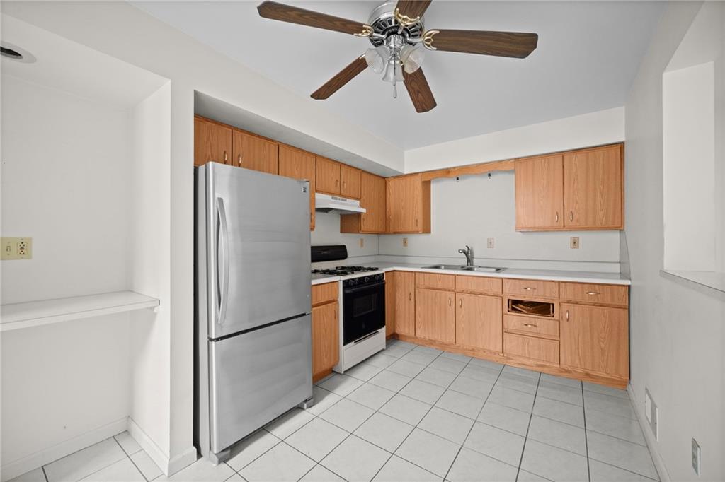 311 Catherine Street McKees Rocks, PA 15136 - Photo 18 of 41 a kitchen with granite countertop stainless steel appliances and white cabinets