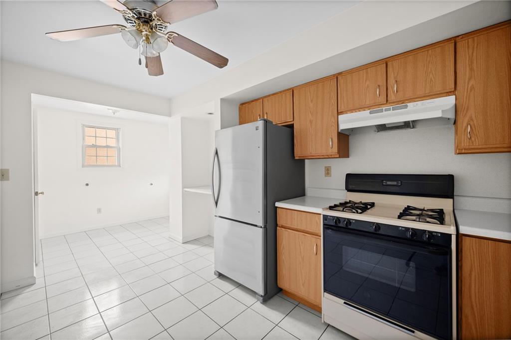 311 Catherine Street McKees Rocks, PA 15136 - Photo 22 of 41 a kitchen with a stove a refrigerator and cabinets