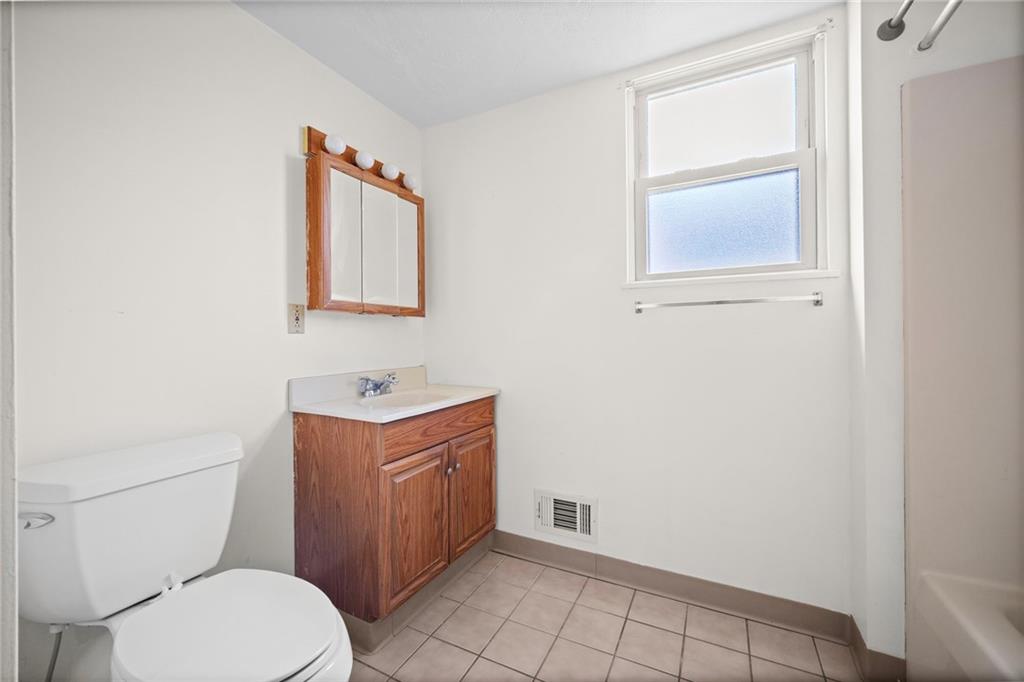 311 Catherine Street McKees Rocks, PA 15136 - Photo 29 of 41 a bathroom with a toilet a sink and mirror