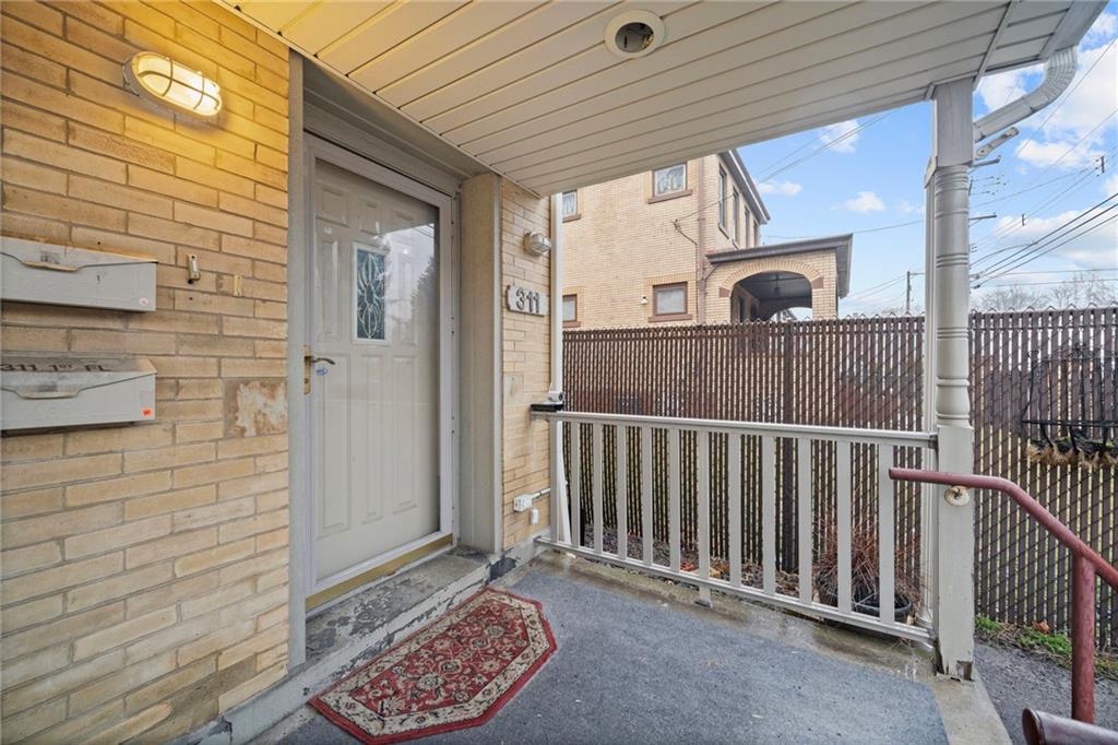 311 Catherine Street McKees Rocks, PA 15136 - Photo 34 of 41 a view of a porch with wooden floor and iron fence