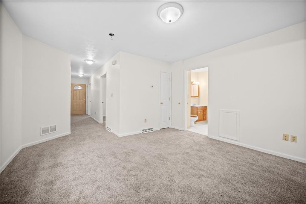 311 Catherine Street McKees Rocks, PA 15136 - Photo 8 of 41 an empty room with chandelier fan and windows