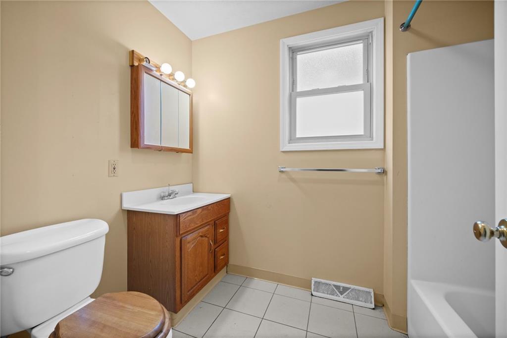 311 Catherine Street McKees Rocks, PA 15136 - Photo 9 of 41 a bathroom with a toilet sink and mirror