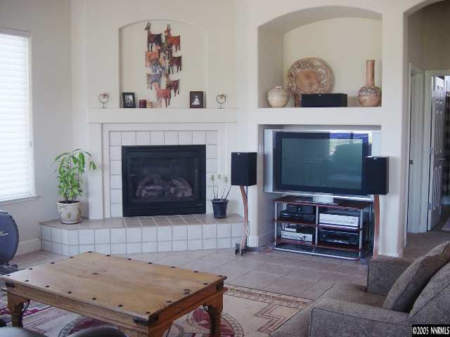 6664 Marble Canyon Road Reno, NV 89511 - Photo 3 of 9 a living room with furniture and a fireplace