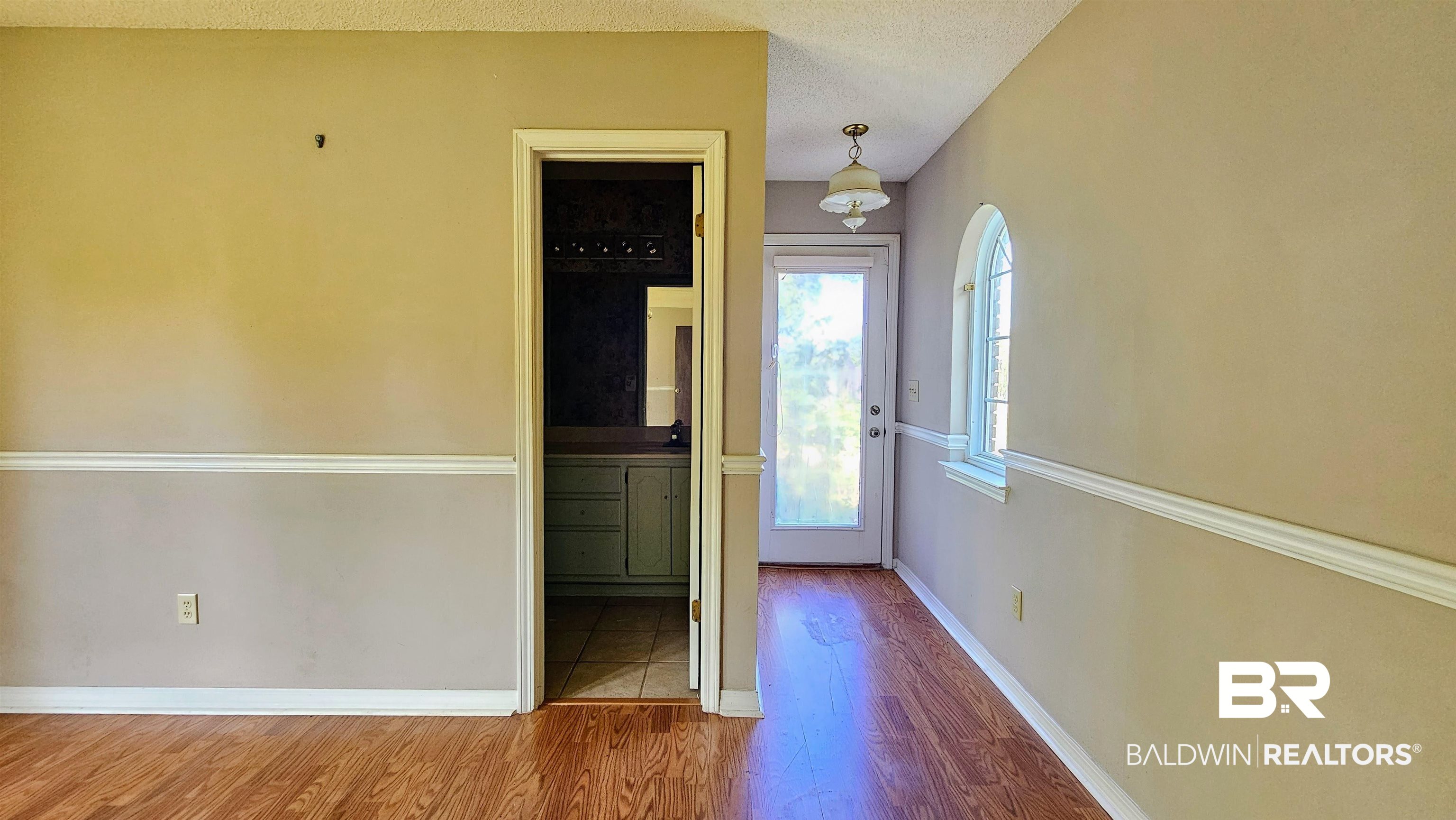 18824 Highway 41 Brewton, AL 36426 - Photo 35 of 40 Interior hallway with wood-finish flooring and two-tone painted walls