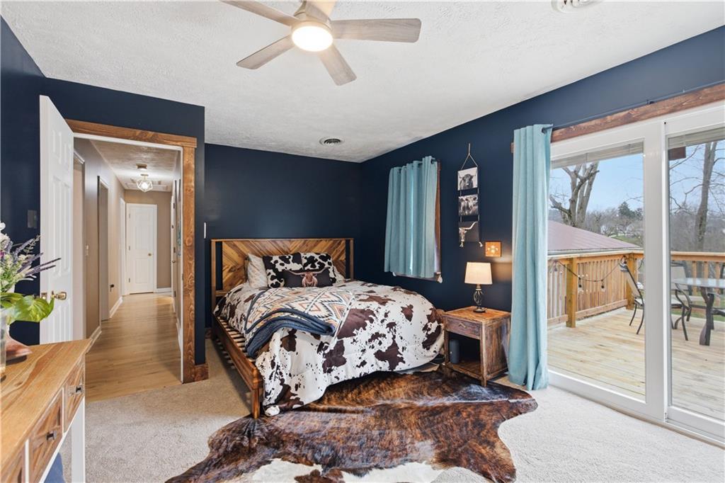 87 Broad Street Marianna, PA 15345 - Photo 16 of 37 a bedroom with a large bed and a chandelier