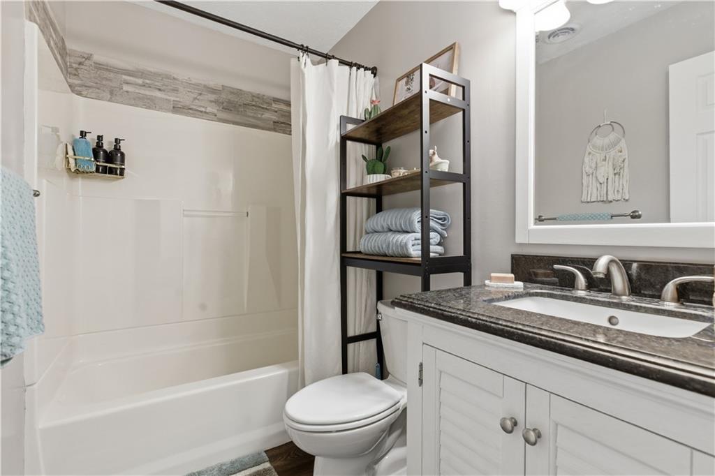 87 Broad Street Marianna, PA 15345 - Photo 22 of 37 a bathroom with a granite countertop sink a toilet and shower