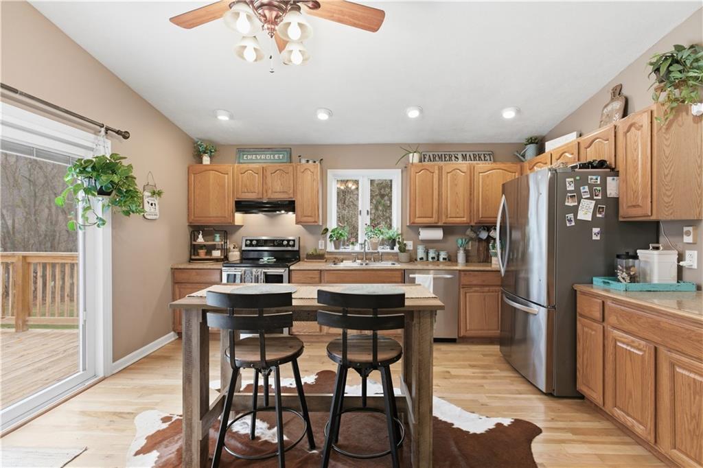 87 Broad Street Marianna, PA 15345 - Photo 10 of 37 a kitchen with stainless steel appliances a dining table chairs and refrigerator