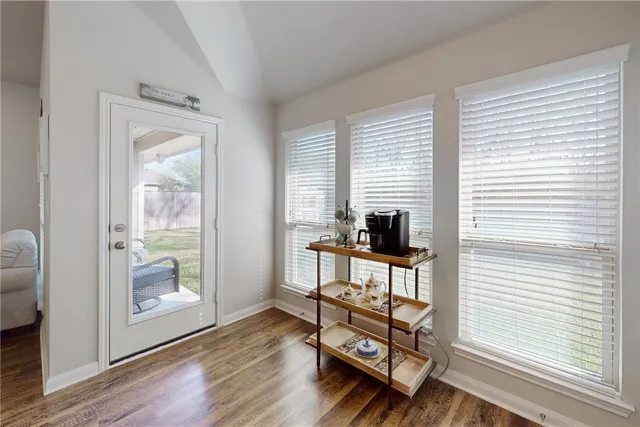 a view of a workspace with furniture and a window