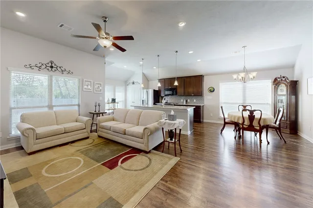 a living room with furniture and a wooden floor