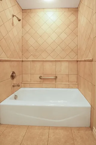 a view of a house with a large tree and a yard