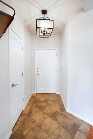 a view of a livingroom with a fireplace wooden floor and chandelier