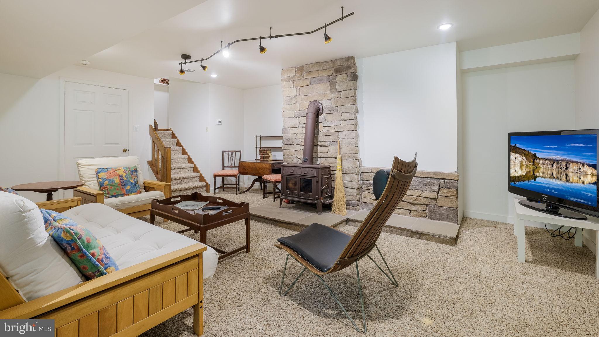 1099 Pebble Hill Road Furlong, PA 18925 - Photo 38 of 64 Family Room with Carpet and Wood Burning FP