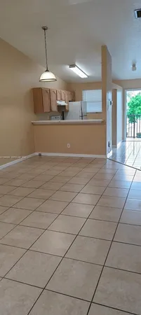 a view of a kitchen with a sink and chandelier fan