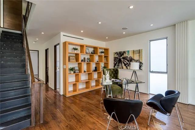 a view of a workspace with furniture and wooden floor