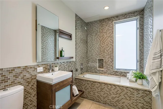 a bathroom with a sink a mirror and a shower