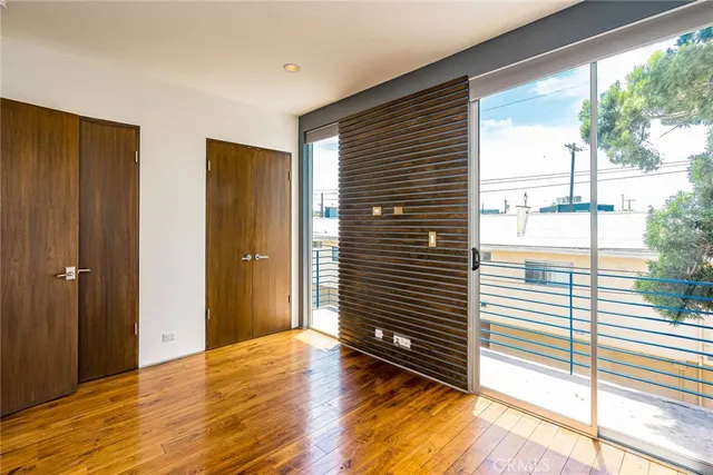 a view of wooden floor and windows in a room