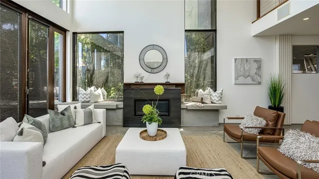 a living room with furniture fireplace and a large window