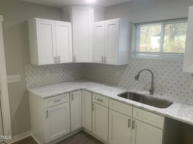 a kitchen with a sink and cabinets