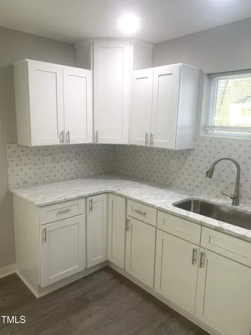 a utility room with a sink and washer