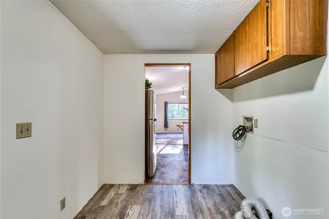 a view of an empty room with closet and a window