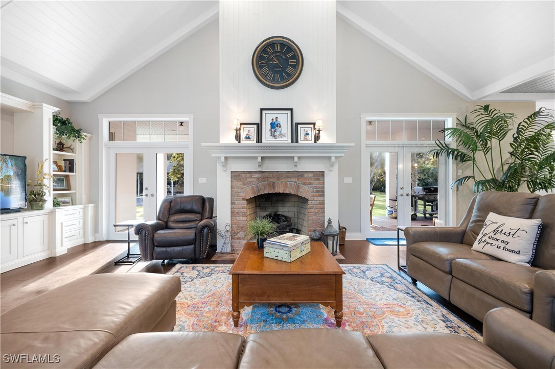 1135 Firebrand Court LaBelle, FL 33935 - Photo 18 of 45 a living room with furniture a clock and a fireplace