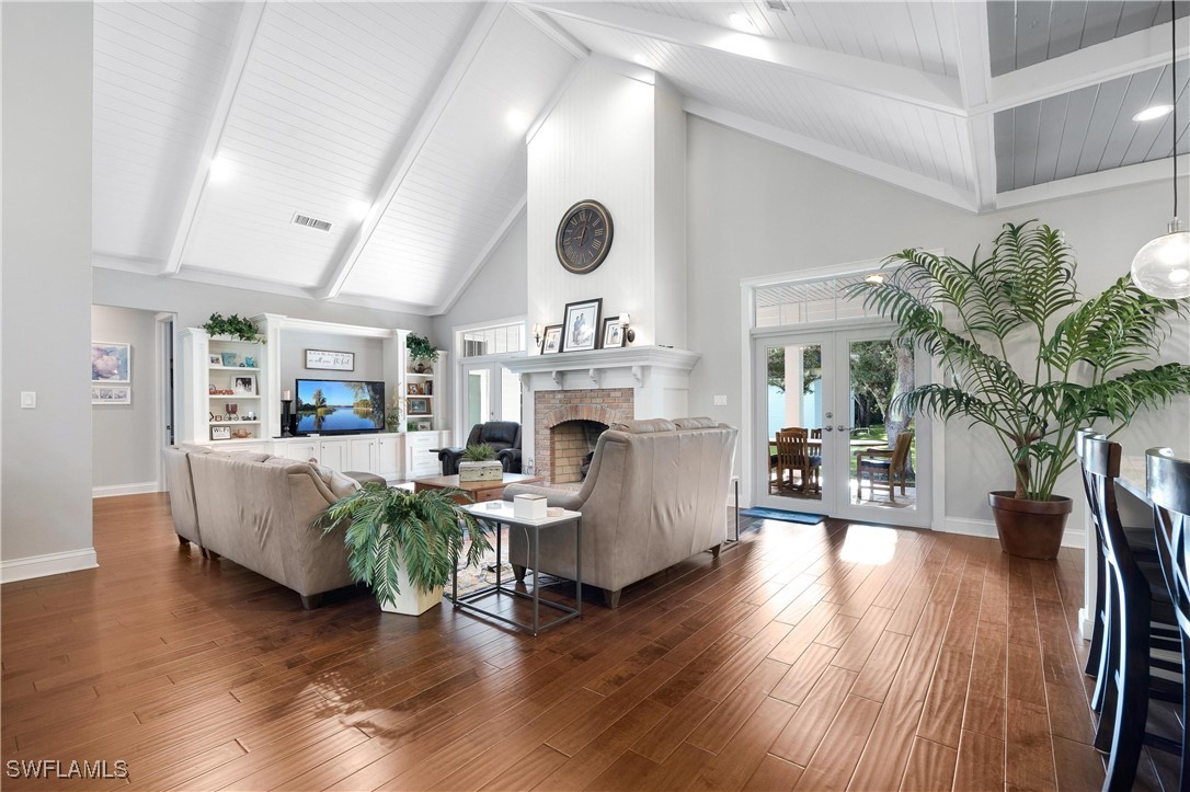 1135 Firebrand Court LaBelle, FL 33935 - Photo 19 of 45 a living room with furniture a fireplace and a flat screen tv