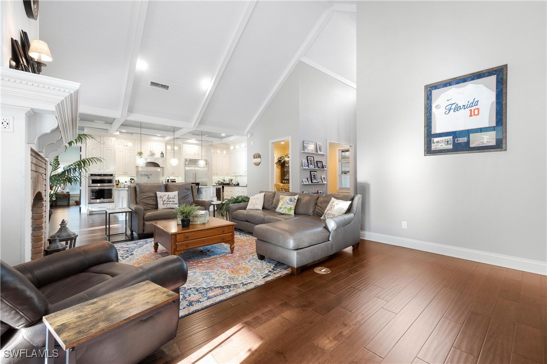 1135 Firebrand Court LaBelle, FL 33935 - Photo 22 of 45 a living room with furniture kitchen view and a wooden floor