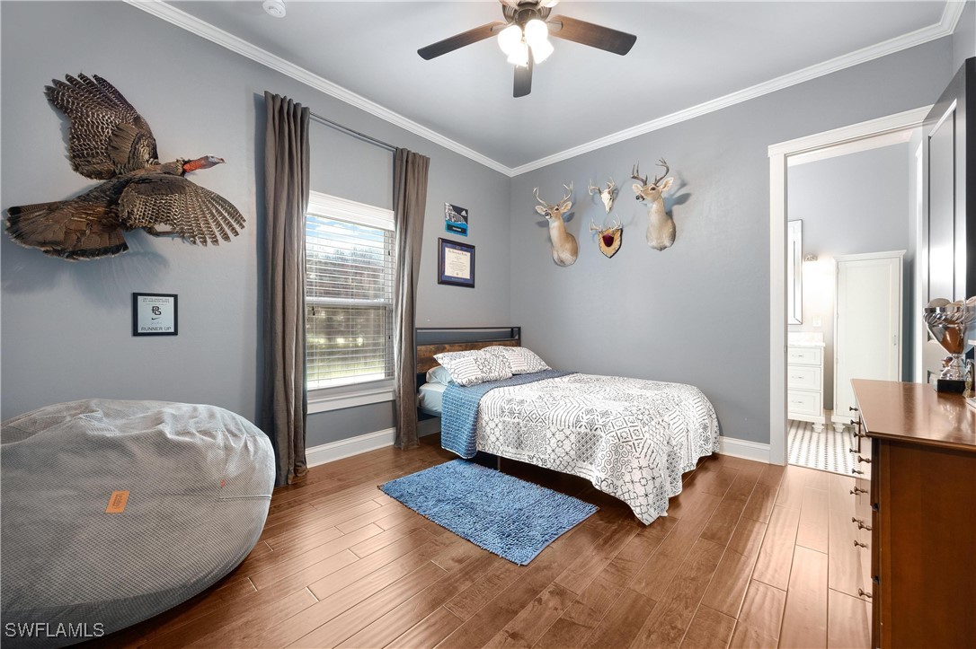 1135 Firebrand Court LaBelle, FL 33935 - Photo 31 of 45 a bedroom with a bed and wooden floor