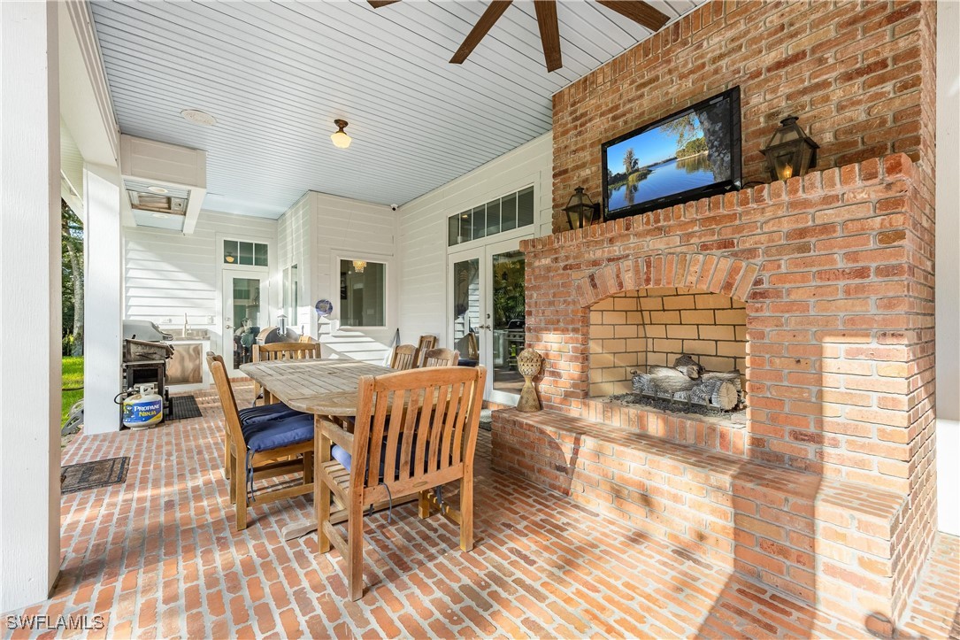 1135 Firebrand Court LaBelle, FL 33935 - Photo 33 of 45 a outdoor space with patio the couches and fireplace with wooden floor