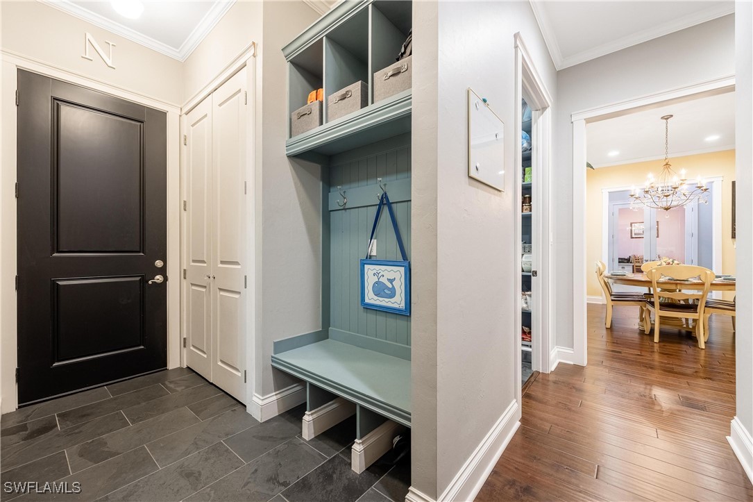 1135 Firebrand Court LaBelle, FL 33935 - Photo 37 of 45 a view of a hallway and dining room with wooden floor