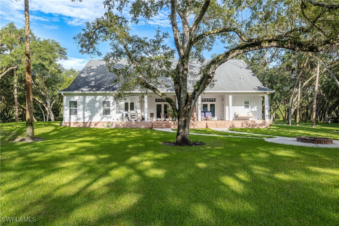1135 Firebrand Court LaBelle, FL 33935 - Photo 40 of 45 a front view of a house with a yard