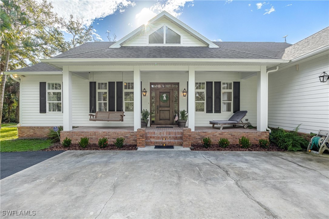 1135 Firebrand Court LaBelle, FL 33935 - Photo 4 of 45 a front view of a house with a yard