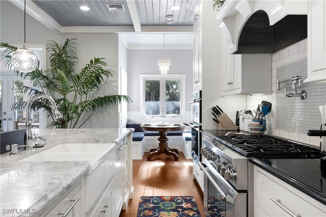 1135 Firebrand Court LaBelle, FL 33935 - Photo 10 of 45 a kitchen with a stove a sink and a table