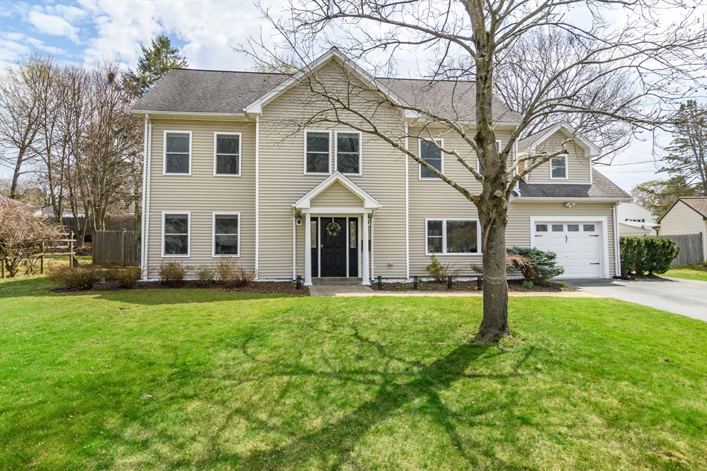 a front view of a house with a garden and porch